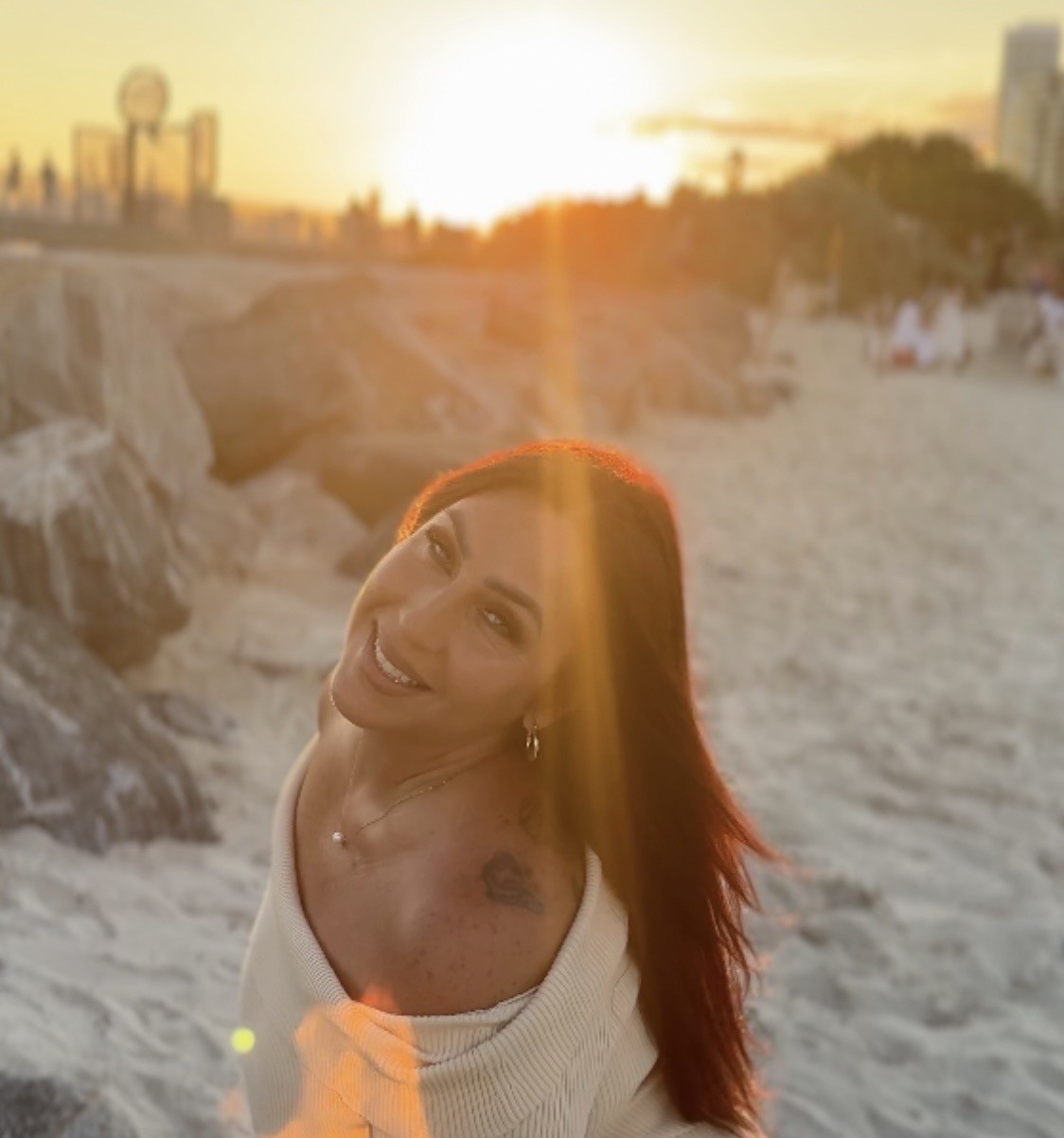Icielani on a beach at sunset.