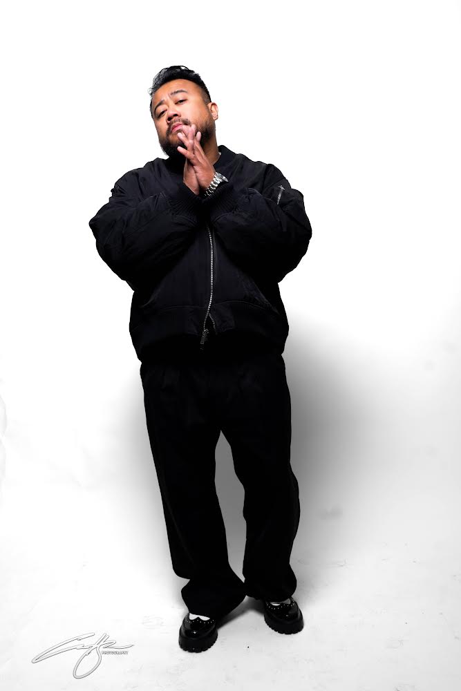 Rocky Sandoval wearing black against a white studio background.